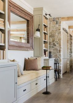 a room with some bookshelves and a bench