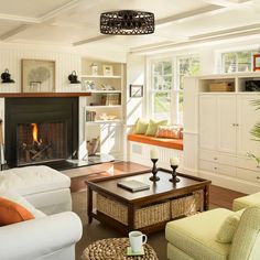 a living room filled with furniture and a fire place