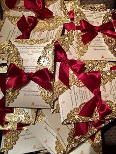 many different types of wedding cards with red bows and gold glitters on the edges