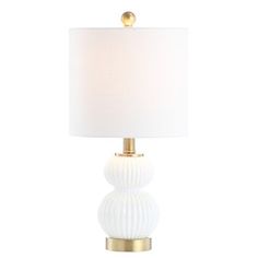 a white table lamp with a gold base and a white fabric shade on the top