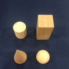 three wooden objects are shown on a blue surface