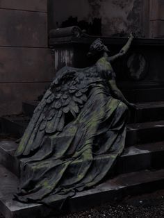 an angel statue sitting on top of some steps