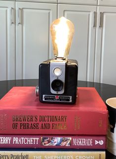 a camera sitting on top of three books