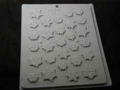 a cookie sheet with snowflakes on it sitting on top of a black surface