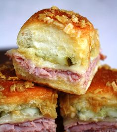 ham and cheese pastrami sandwiches stacked on top of each other with melted cheese