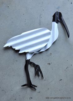 a stork made out of paper on the ground