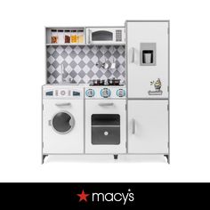 a play kitchen with white appliances and checkered wallpaper on the back ground, in front of an advertisement for macy's