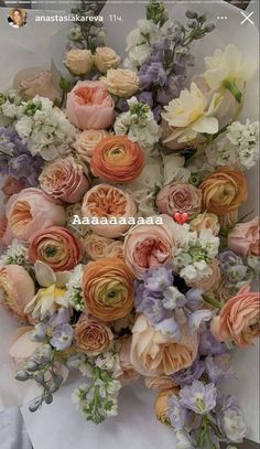 a bunch of flowers that are sitting on a white table cloth, with the words anasabasa in front of it