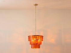 a chandelier hanging from the ceiling in a room with white walls and flooring