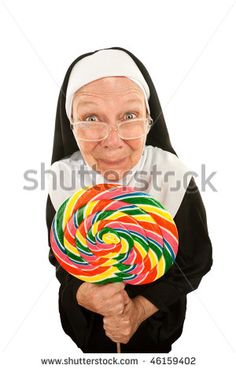 a nun holding a lollipop in her hands and making a funny face on the camera