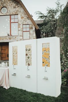 a couple of white doors sitting next to each other on top of a grass covered field