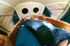 the inside of a small boat with two beds