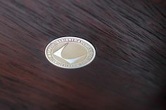 a close up of a wooden table with a coin on it's surface,