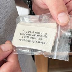 a person holding a piece of cloth with a quote on it