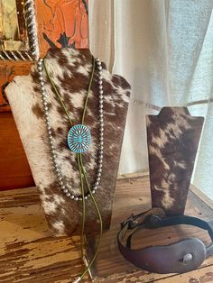 We love these Ranch Style necklace + jewelry displays. Hair on cowhide available in your choice of cowhide color! We can personalize it with your cattlebrand, initials etc. If you have an idea in mind, message us with any questions. They look so pretty in your bedroom, vanity, etc. Perfect to display your fav Squash blossom, Navajo Pearls etc!  Two sizes available: Small + Large  Available: Small: 8.5"x4" Large: 12.5"x 8" This listing is for the Large Cowhide Display Ideas, Cowhide Bedroom Ideas, Rustic Boutique Ideas, Western Jewelry Holder, Cowhide Necklace, Boutique Jewelry Display, Boho Jewelry Display, Gift Shop Displays, Rustic Jewelry Display