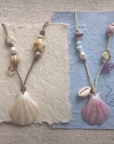 three seashells and pearls are on display