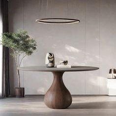 a round table with two vases on it and a lamp hanging from the ceiling