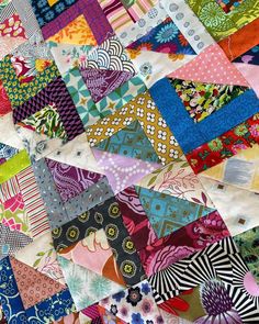 a colorful patchwork quilt with many different patterns on it's edges and sides