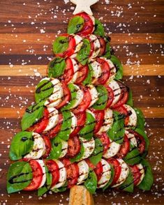 a christmas tree made out of tomatoes and mozzarella