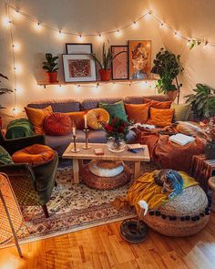 a living room filled with lots of furniture and plants on top of the couches