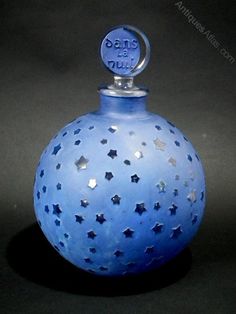 a blue glass bottle with silver stars on it