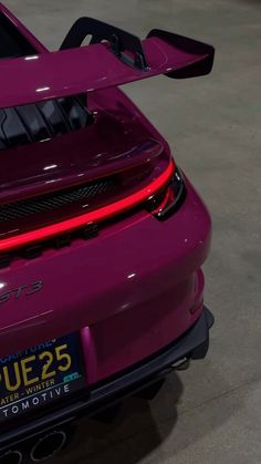 the rear end of a purple sports car