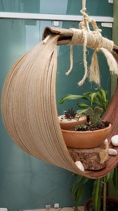 a hanging planter filled with succulents and rocks