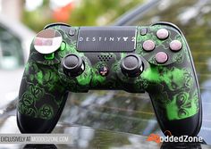 a close up of a video game controller on a car's hood with the word destiny 2 printed on it