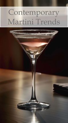 a close up of a martini glass on a table with the words contemporary martini trend