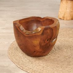 a wooden bowl sitting on top of a rug