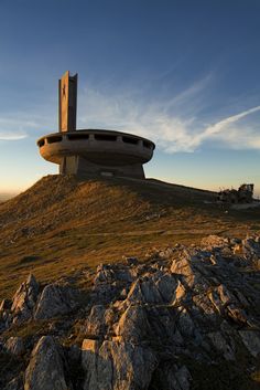 an unusual building on top of a hill