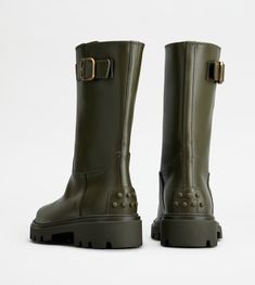 Biker boots in semi-shiny leather, with branded metal side buckle. Featuring the iconic rubber pebbles on the heel, they are characterized by a rubber lugged outsole. An urban passe-partout with a bold and refined touch at once. Green Leather Boots With Lug Sole, Green Ankle Boots With Lug Sole, Green Leather Ankle Moto Boots, Green Waterproof Leather Boots, Leather Biker Boots, East Hampton, Biker Boots, Boots For Women, Womens Boots