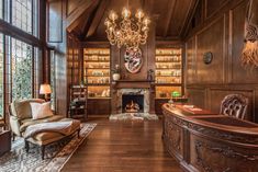 an elegant living room with wood paneling and chandelier