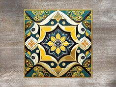 an artistic tile design in gold, blue and green on a wood background with text