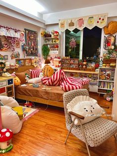 a living room filled with lots of furniture and decor on top of hard wood floors