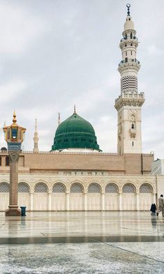 a large white building with a green dome