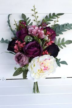 a bouquet of flowers sitting on top of a white table