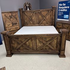 a bed with wooden frame and drawers in a room