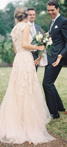 a bride and groom standing in front of an outdoor wedding ceremony with their hands on each other's waist