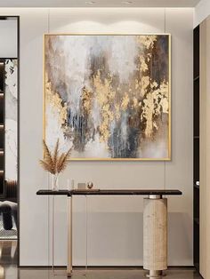 an abstract painting hangs on the wall above a console table in a modern living room