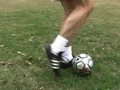 a person in white socks kicking a soccer ball