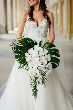 a woman in a wedding dress holding a bouquet