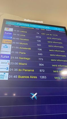 an airplane is flying over the airport information board