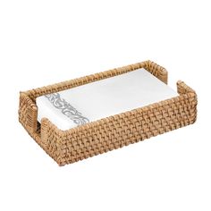 a wicker tray with white linens on top and silver trim around the edge