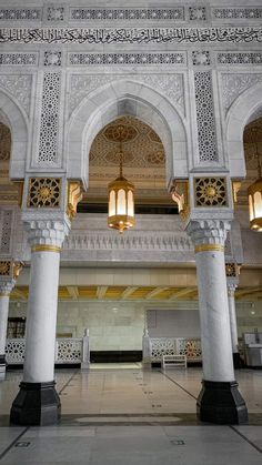 the inside of a building with columns and lights