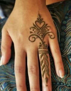 a woman's hand with a henna tattoo on it