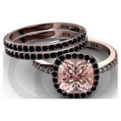 two engagement rings with a pink diamond in the center and black diamonds on each band