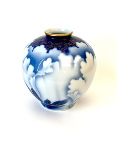 a blue and white vase sitting on top of a table