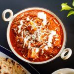 a bowl of chili and tortillas on a table