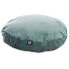 a green round dog bed on a white background